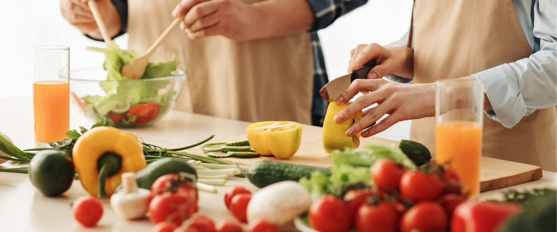 People preparing a colourful, fresh meal